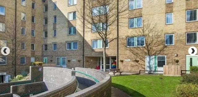 Building exterior with windows and a picnic table exterior at Dinwiddy House in London Student Accommodation