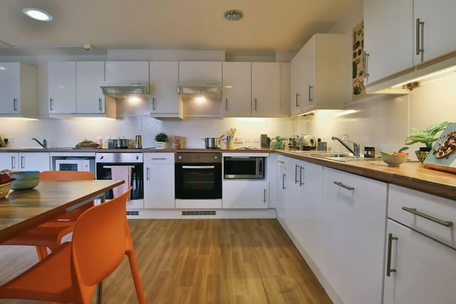 Kitchen with white cabinets oven sink and table at Victoria Court in Lancaster Student Accommodation