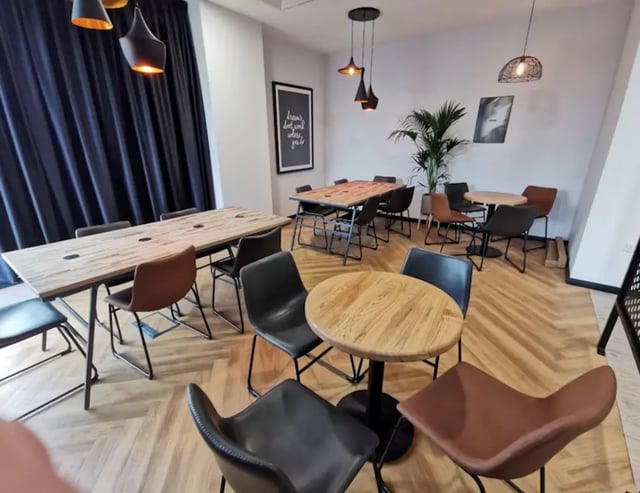 Tables and chairs in communal dining area at Little Patrick Street in Belfast Student Accommodation