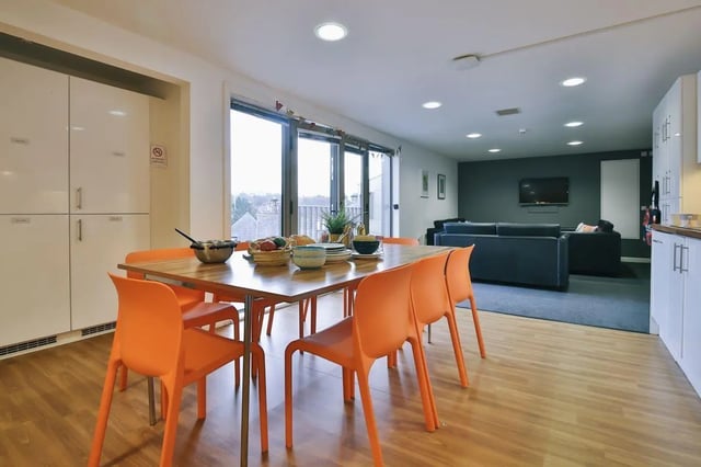 Dining table with orange chairs communal living area at Victoria Court in Lancaster Student Accommodation