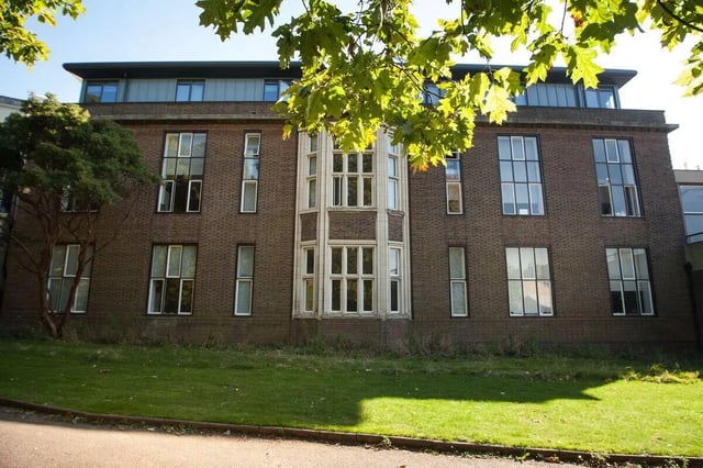 Brick building many windows green lawn exterior at Library Lofts in Exeter Student Accommodation