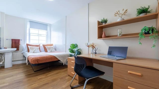 Bed desk with laptop and chair bedroom at Garth Heads in Newcastle Upon Tyne Student Accommodation