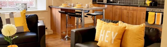 Chairs and cushions in a living room kitchen area at Garth Heads in Newcastle Upon Tyne Student Accommodation