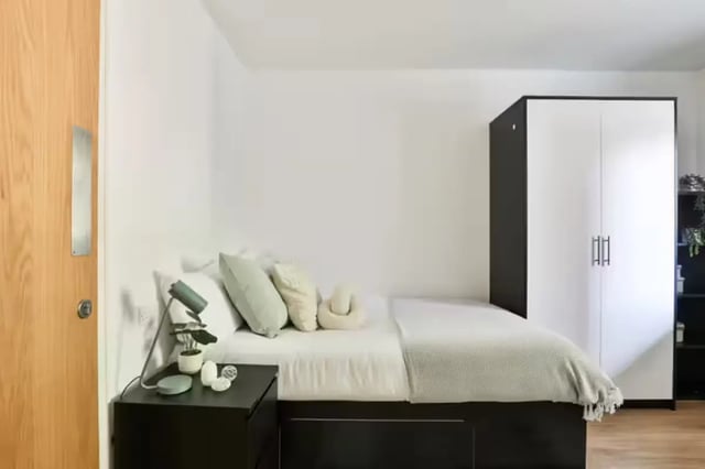 Bed nightstand lamp pillows wardrobe bedroom at Hayward House in Liverpool Student Accommodation