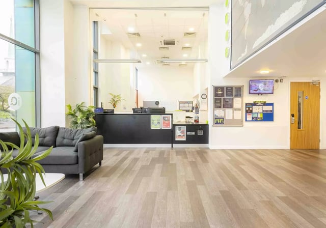 Sofa reception desk notice boards and TV lobby at iQ Astor House in Plymouth Student Accommodation
