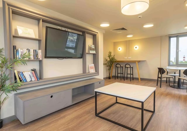 Bookshelf television modern coffee table living room at iQ Astor House in Plymouth Student Accommodation