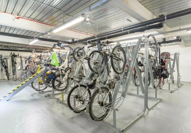Multiple bicycles parked on racks bicycle storage area at iQ Astor House in Plymouth Student Accommodation