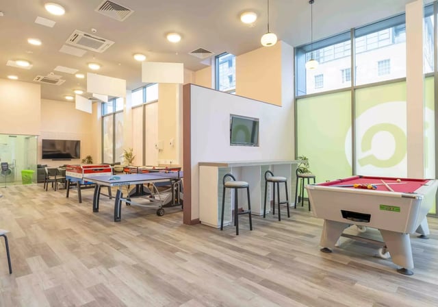 Ping pong tables pool table bar stools lounge area at iQ Astor House in Plymouth Student Accommodation