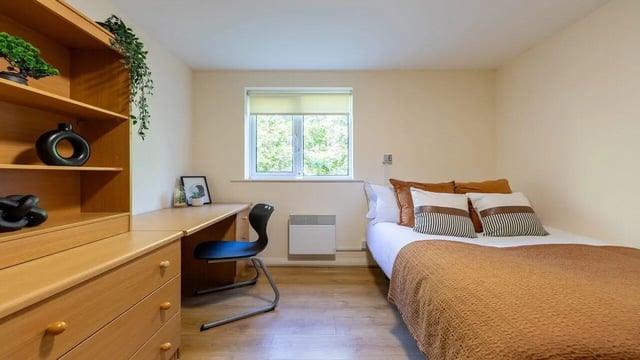 Bed desk chair shelves window bedroom at Weston Court in Manchester Student Accommodation