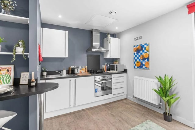 Modern kitchen with white cabinets oven and dining bar kitchen at Alwyn Court in Cardiff Student Accommodation