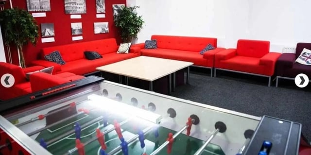 Foosball table couches table plants living room at Alliance House in London Student Accommodation