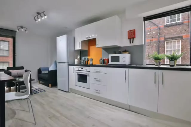 Modern kitchen with oven fridge microwave and living room kitchen at Maple House in Liverpool Student Accommodation