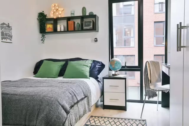 Bed with green pillows beside nightstand bedroom at Maple House in Liverpool Student Accommodation
