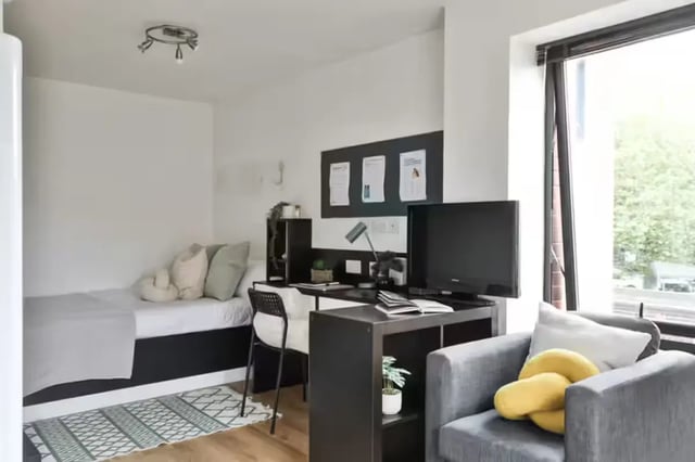 Bed desk chair TV armchair with cushions bedroom at Maple House in Liverpool Student Accommodation