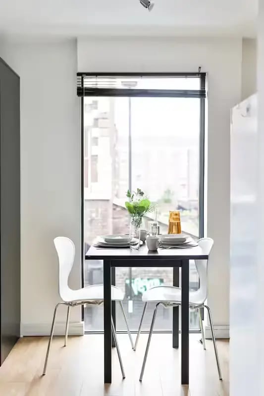 Table chairs vase and plates dining area at Maple House in Liverpool Student Accommodation
