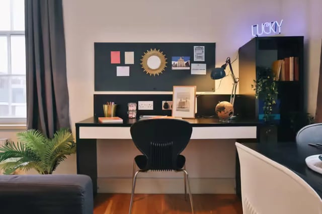 Desk with chair plant and neon sign study area at Art School Lofts in Liverpool Student Accommodation