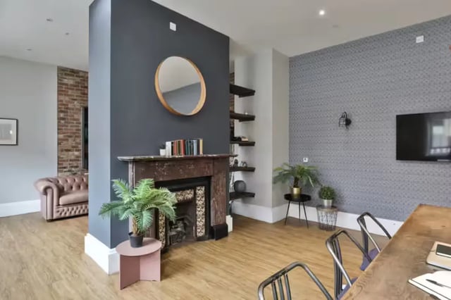 Fireplace Chesterfield sofa patterned wall TV living room at Art School Lofts in Liverpool Student Accommodation