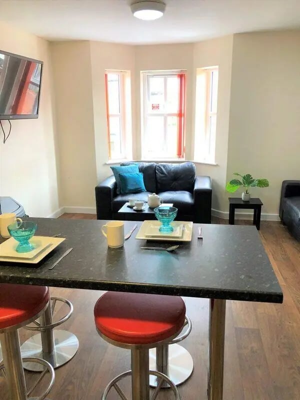 Counter with stools and sofa living room at Waterside Court in Chester Student Accommodation