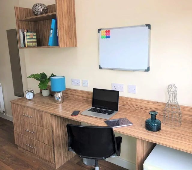 Desk with laptop whiteboard and chair study area at Waterside Court in Chester Student Accommodation
