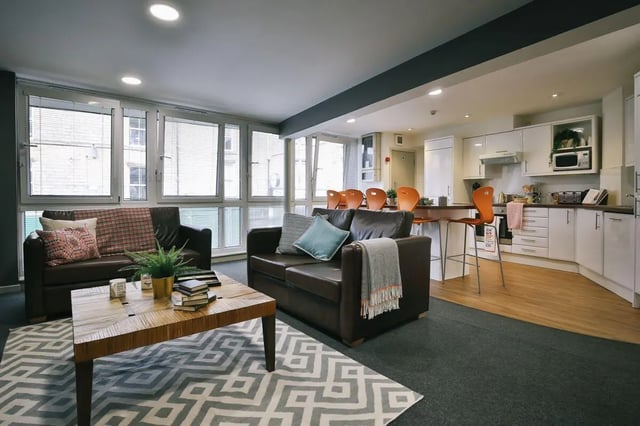 Two leather sofas kitchen with bar island living room at 77 Penny Street in Lancaster Student Accommodation