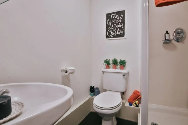 Toilet sink shower plants sign bathroom at 77 Penny Street in Lancaster Student Accommodation