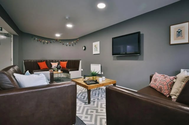 Leather sofas tv and geometric rug living room at 77 Penny Street in Lancaster Student Accommodation