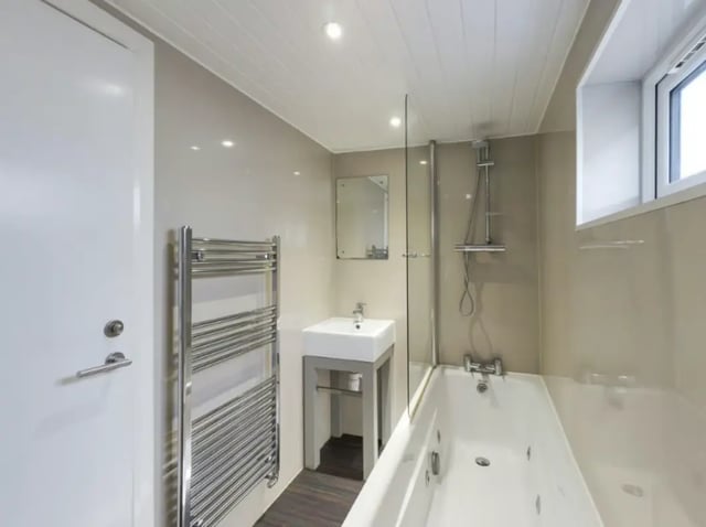 Bathroom with sink towel rack bathtub and shower. at 26 Beresford Street in Stoke-On-Trent Student Accommodation