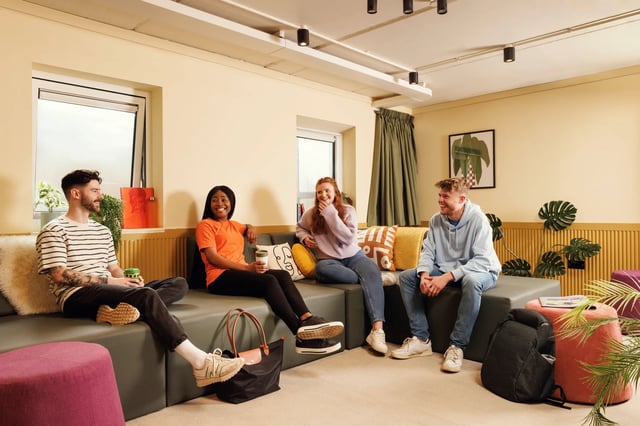 Four students sitting on a sofa living room at The Bridge House in Edinburgh Student Accommodation