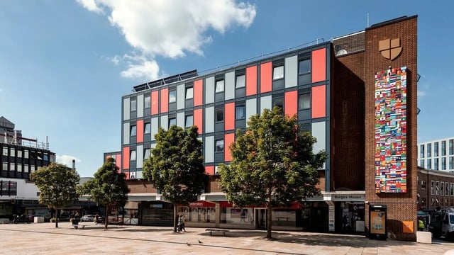 Modern building with colorful facade and flag mural exterior at Burges House in Coventry Student Accommodation