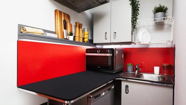 Microwave sink and cabinets in a kitchen at Burges House in Coventry Student Accommodation
