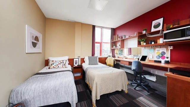 Two beds desk study area microwave and chair bedroom at Burges House in Coventry Student Accommodation