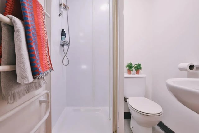 Shower toilet and sink with towels bathroom at 99 Penny Street in Lancaster Student Accommodation