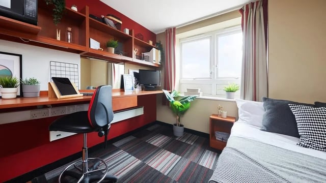 Desk chair shelves bed pillows study area bedroom at Market Way in Coventry Student Accommodation