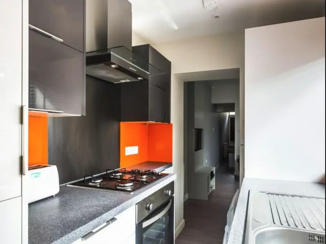 Modern kitchen with gas hob and orange splashback kitchen at 28 Seaford Street in Stoke-On-Trent Student Accommodation