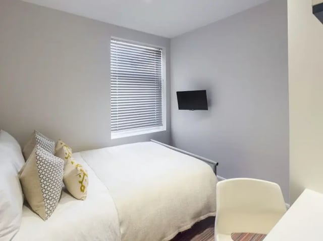 Bed with pillows and wall mounted TV bedroom at 28 Seaford Street in Stoke-On-Trent Student Accommodation