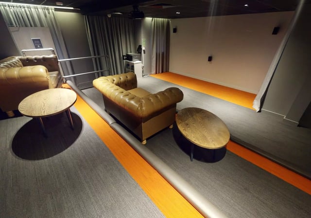 Leather sofas with wooden tables lounge area at iQ Fenton House in Sheffield Student Accommodation