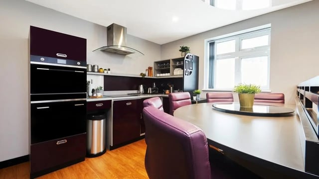 Modern kitchen with dining table and purple chairs kitchen at Pillar Box in Coventry Student Accommodation