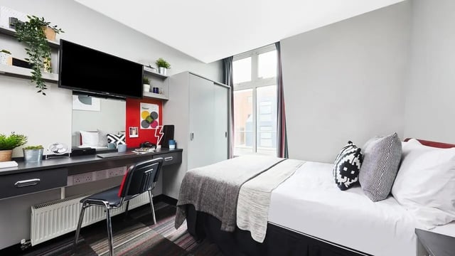 Desk TV wardrobe bed pillows bedroom at Pillar Box in Coventry Student Accommodation