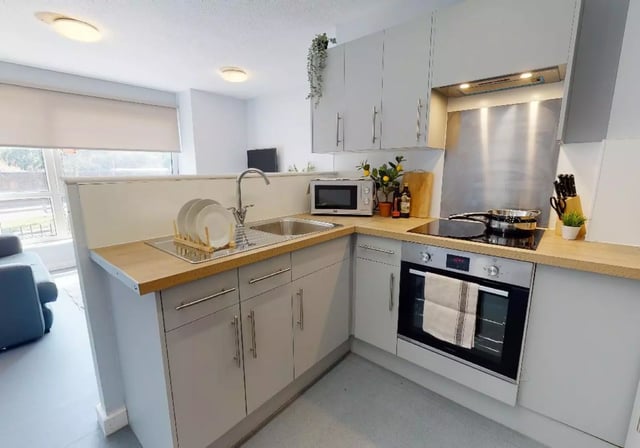 Kitchen with sink microwave oven and cabinets kitchen at iQ Fiveways House in Wolverhampton Student Accommodation