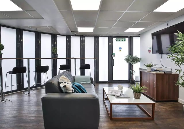Sofa coffee table and bar stools living room at iQ Fiveways House in Wolverhampton Student Accommodation