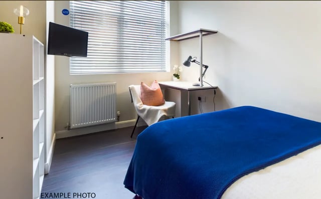 Bed desk chair radiator TV bookshelves bedroom at 29 Guildford Street in Stoke-On-Trent Student Accommodation
