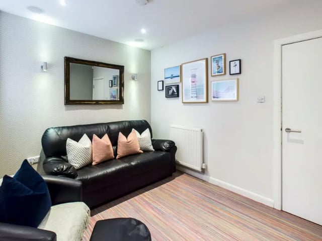 Black sofa with patterned cushions living room at 29 Guildford Street in Stoke-On-Trent Student Accommodation