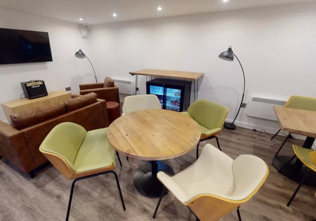 Leather sofas round table mini fridge lounge at iQ Great Newton House in Liverpool Student Accommodation