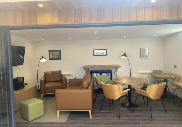 Lounge with sofas chairs tables and mini fridge living room at iQ Great Newton House in Liverpool Student Accommodation