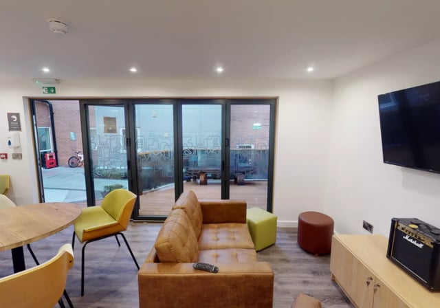 Sofa table chairs TV amp and cabinets living room at iQ Great Newton House in Liverpool Student Accommodation