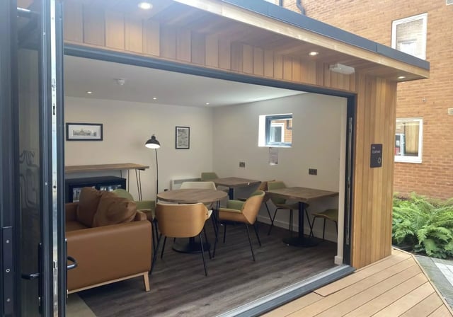 Sofa tables chairs bar and lamp communal area at iQ Great Newton House in Liverpool Student Accommodation