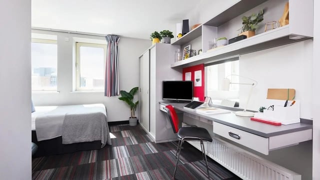 Bed desk chair and shelves student bedroom at Corporation Village in Coventry Student Accommodation