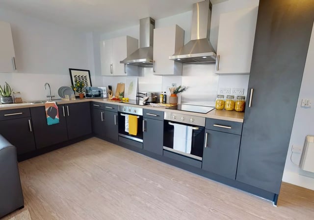 Modern kitchen with dark cabinets and ovens Kitchen at iQ Magenta House in London Student Accommodation