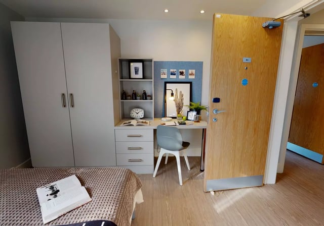 Wardrobe desk chair clock bed and door Bedroom at iQ Magenta House in London Student Accommodation
