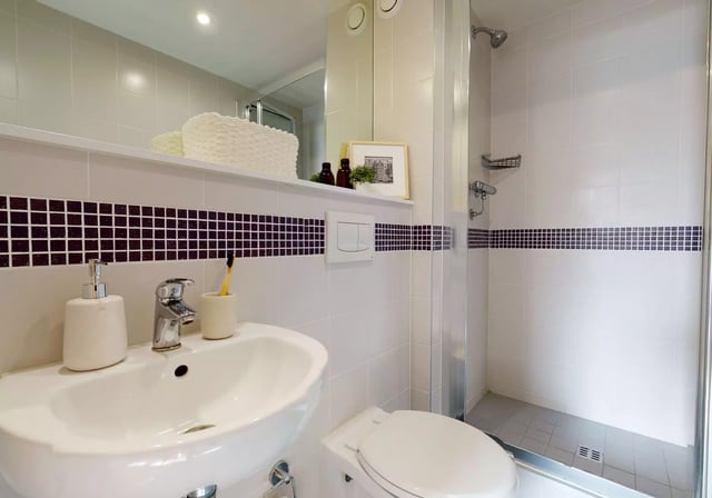 Sink toilet shower soap dispenser toothbrush bathroom at iQ Magenta House in London Student Accommodation